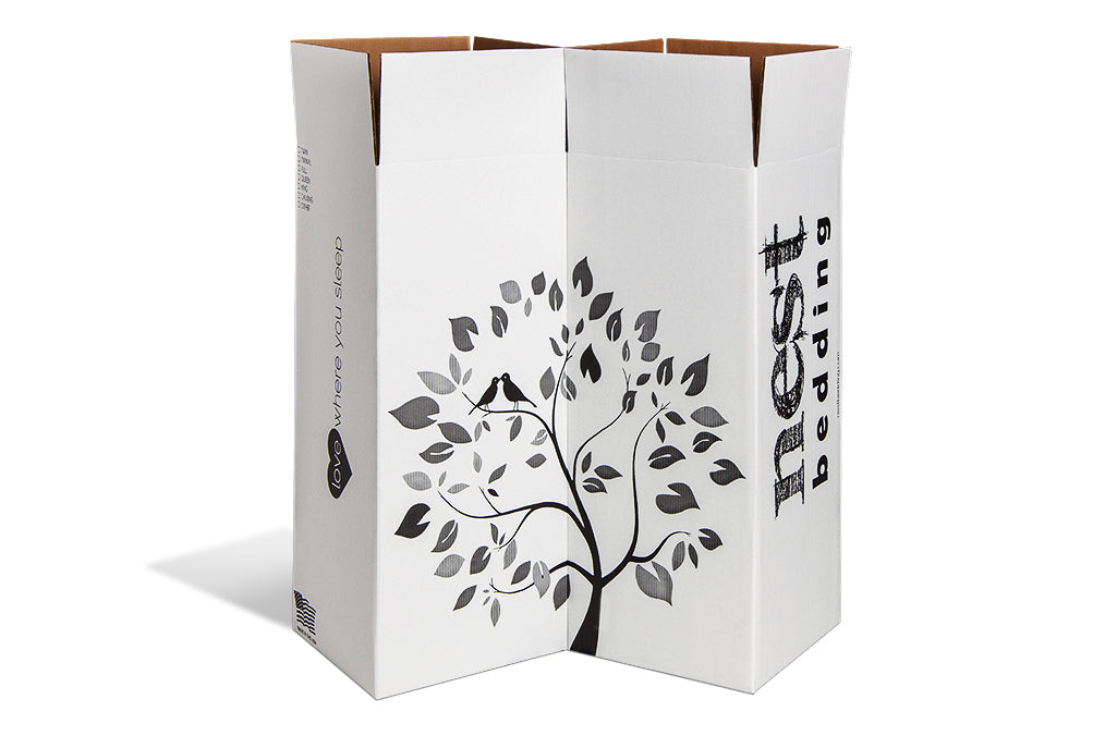 Two white Nest Bedding mattress boxes aligned to show the Nest Bedding tree logo.